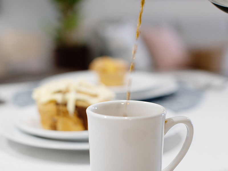White coffee mug being filled with coffee