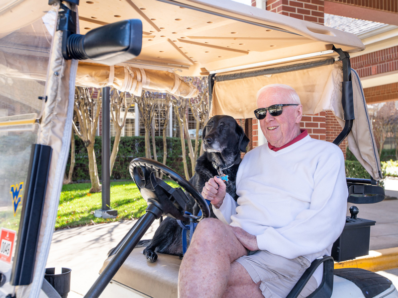 FWB-wellness03-1400x900 Senior man and dog sitting in golf cart