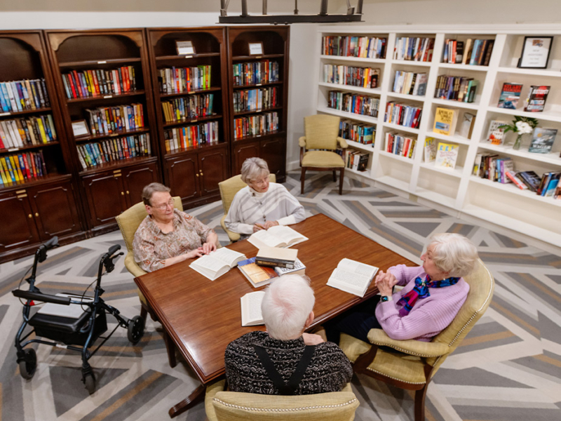 book-club-925x875 Group of 4 seniors sitting a table studying books