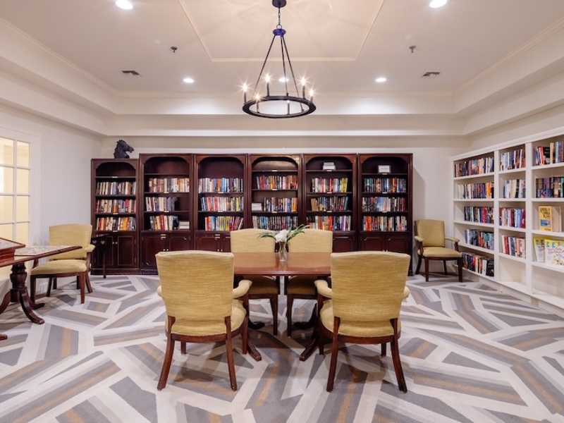 Senior living library with chairs and table