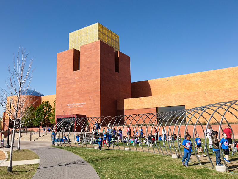 Exterior view of a school with children playing under walk way