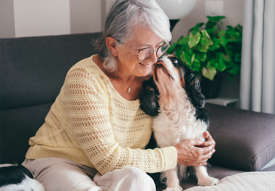 Senior woman with loving puppy
