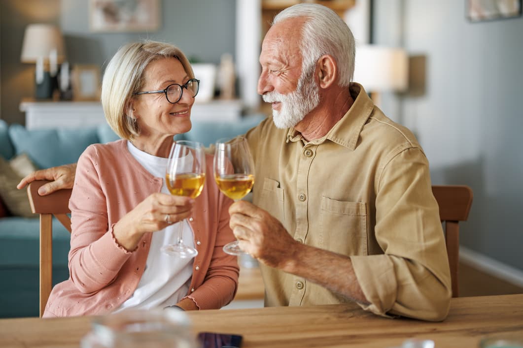 Broadway_Happy Hour with The Lovelace Duo-Event Image_01-29-2026 Senior couple toasting wine glasses at their dining room table