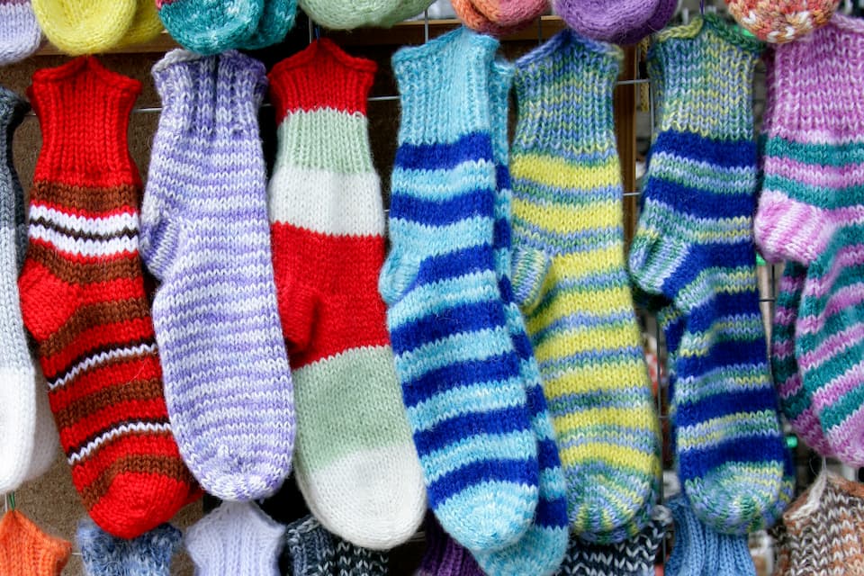 Broadway_Wacky Sock Happy Hour_01-29-2026 Colorful knit socks hung up in a row