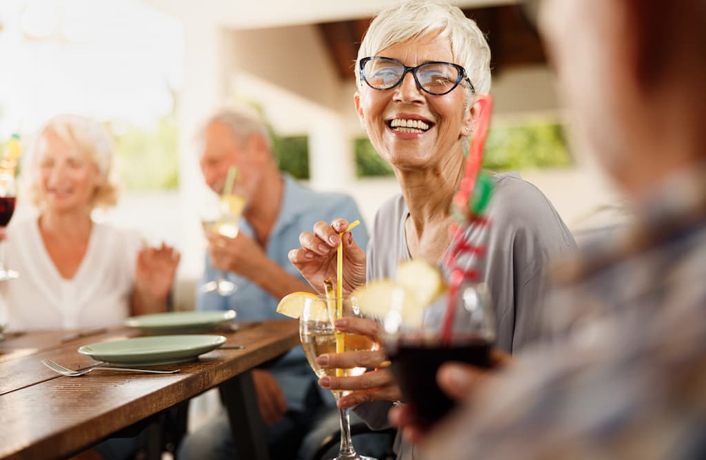 Broadway_Berry Sweet Happy Hour with Bud and Larry-Image_04-30-2026 senior woman enjoying a drink with friends around a table