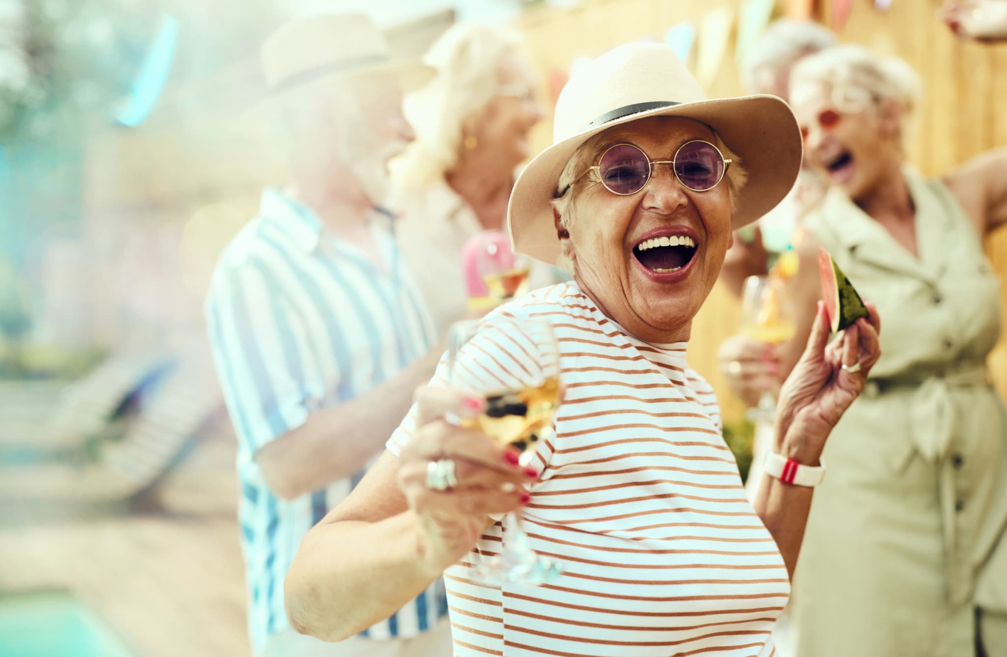 senior woman dancing at a summer party outdoors