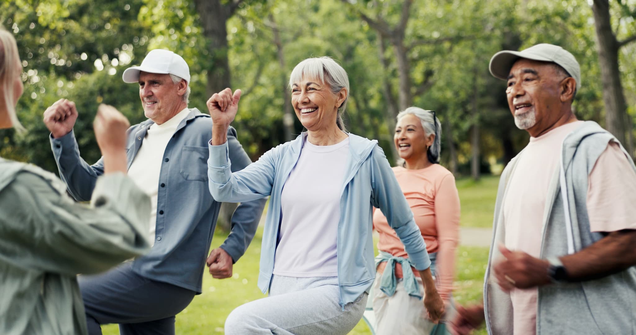 outdoor-group-workout-older-adults Group of older adults moving during outdoor exercise class