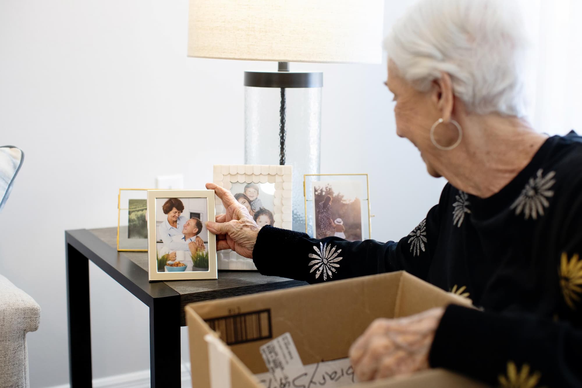 Senior woman looking at framed images